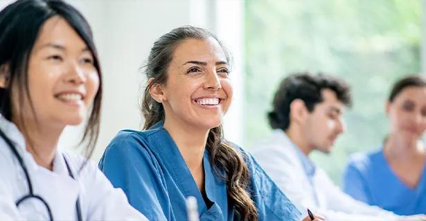 Nurse smiling amongst peers