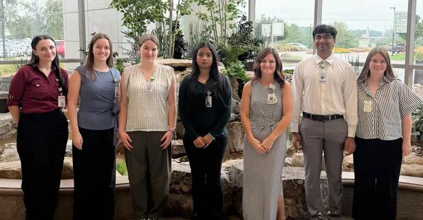 Purdue students standing in front of the PRMC waterfall