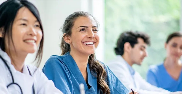 Nurse smiling amongst peers