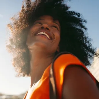 Woman smiling with sun shining