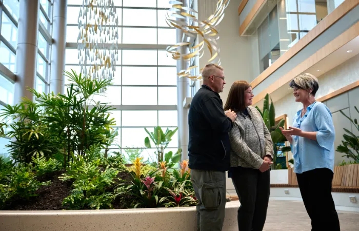 PFCI person talking to patients in the PFCI building