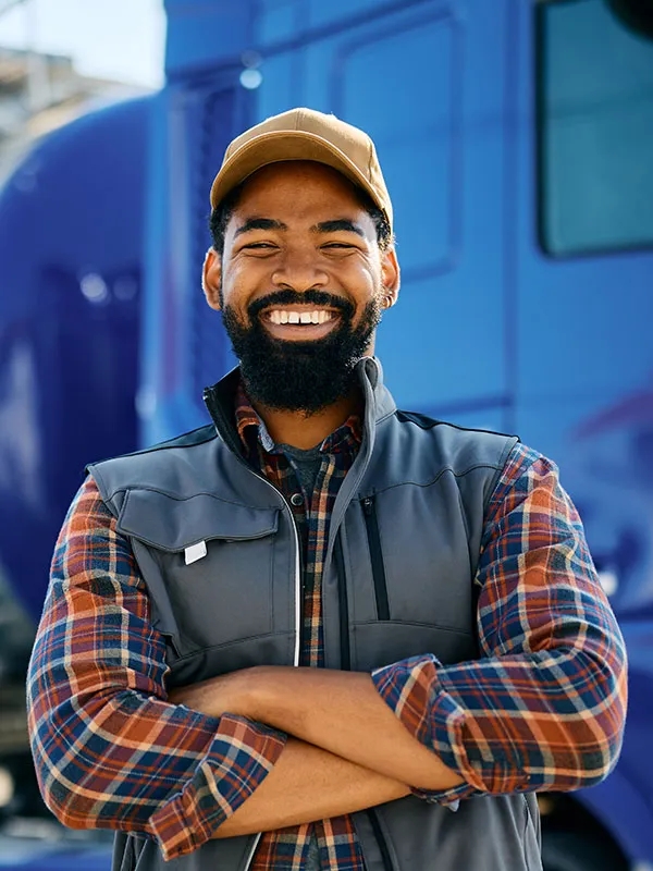 Semi truck driver smiling outside