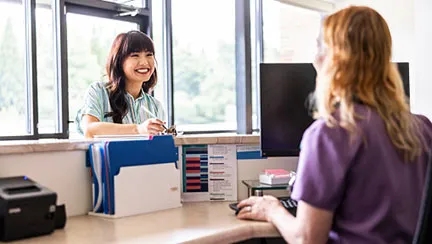 woman checking in at front desk